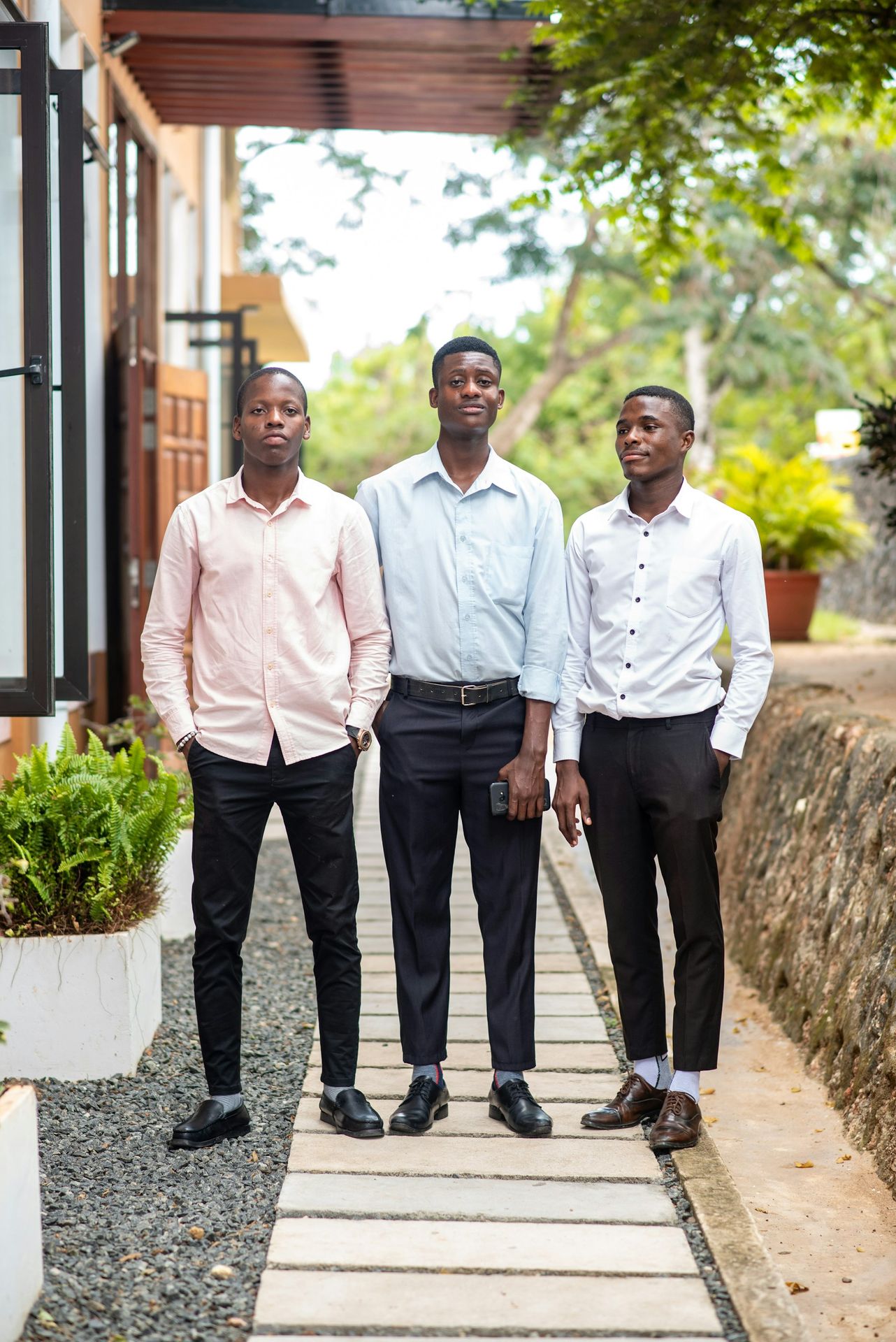 a group of three men standing next to each other